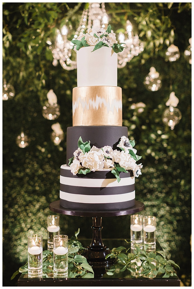 black, white, and gold wedding cake